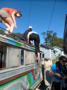 climbing onto the roof of a jeepney