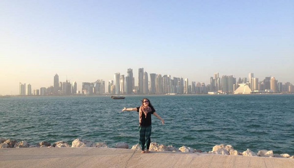 Girl standing in front of the Doha skyline in Qatar