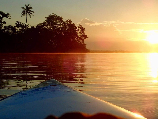 Sunrise stand-up paddleboarding at Bacalar Lagoon