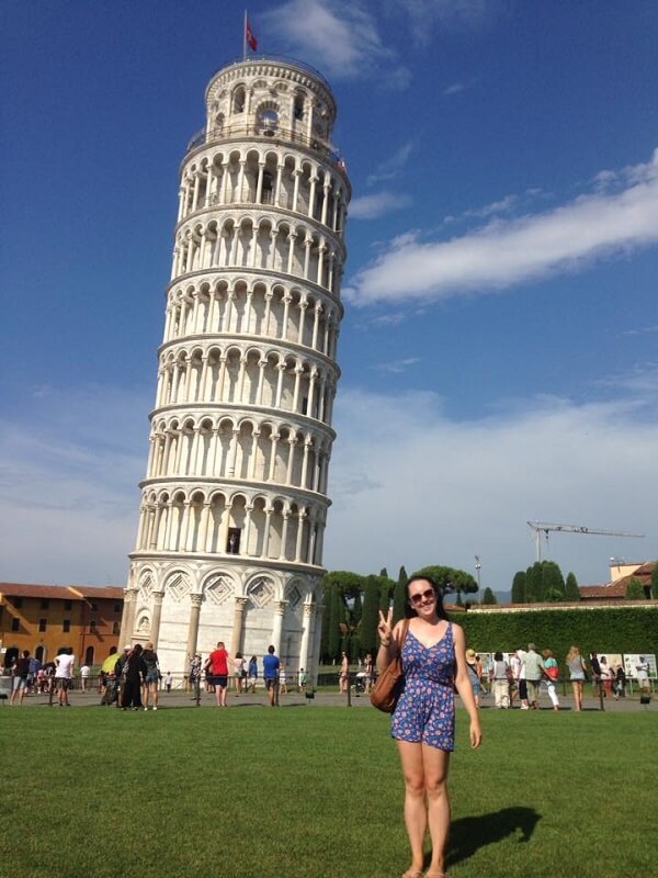 Posing next to the Leaning Tower of Pisa in Italy