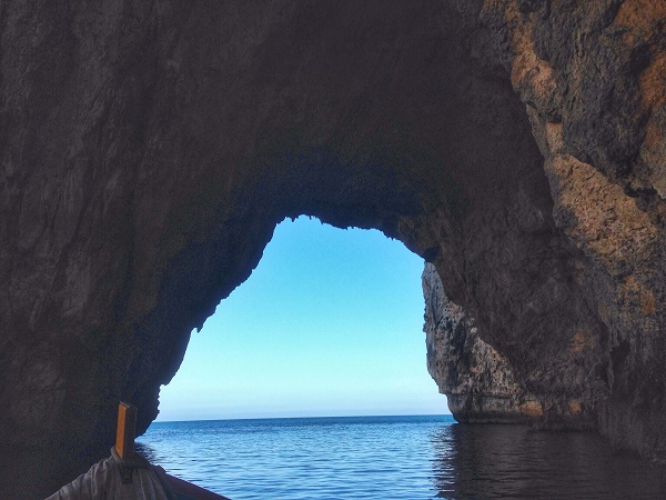 On a boat trip around the blue grotto rock formations in Malta