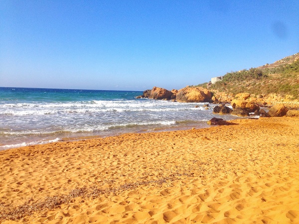 The red sand of Ramla Beach on Gozo, Malta, near sunset