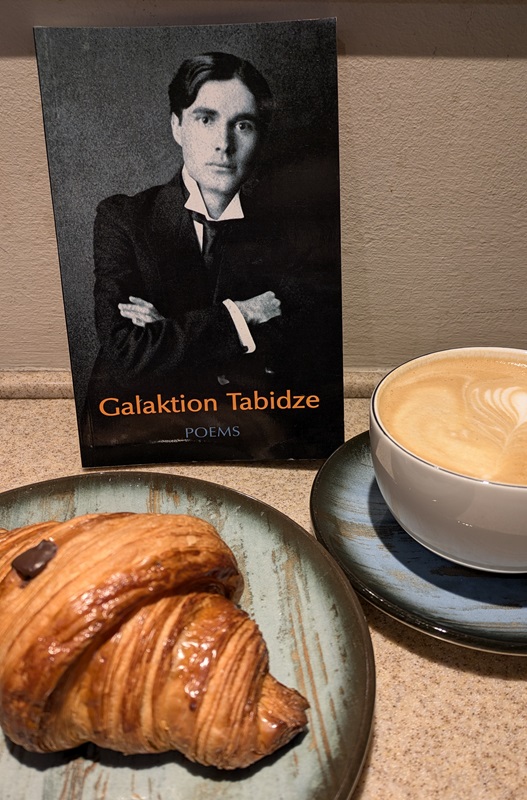 Galaktion Tabidze Poems book with a croissant and coffee